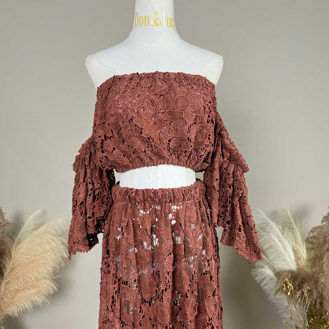 The Bendis, terracotta two-piece lace maternity photography set displayed on a mannequin, featuring an off the shoulder ruffled crop top details.