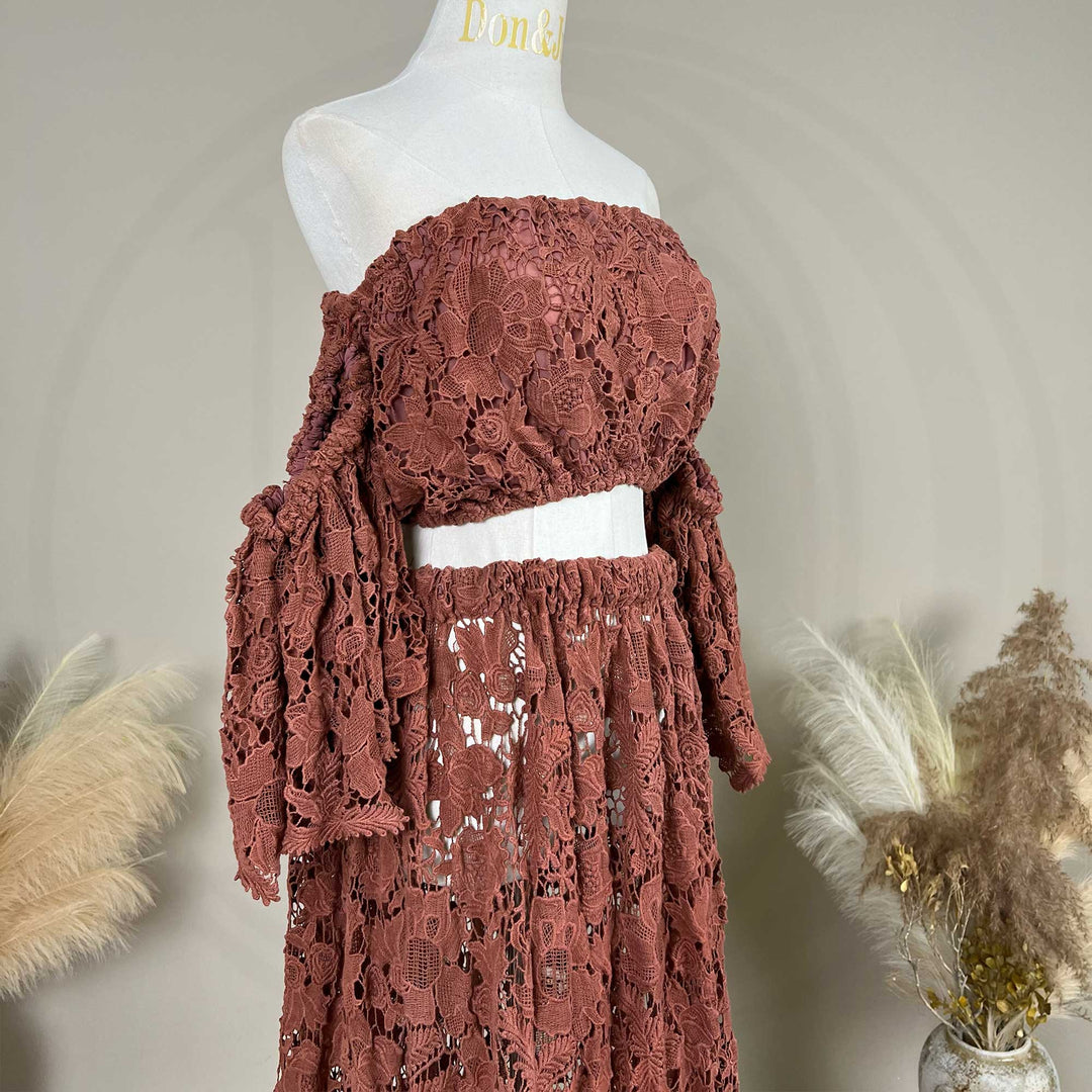 The Bendis, terracotta two-piece lace maternity set displayed on a mannequin, featuring an off the shoulder ruffled crop top details.