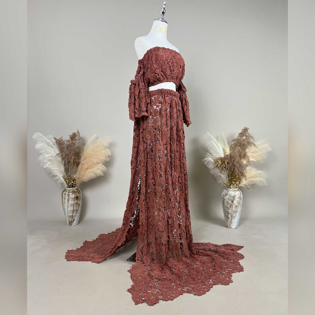 A terracotta,Bendis two-piece displayed on a mannequin, featuring an off the shoulder ruffled crop top and a high waisted floor length skirt with a sweeping train.